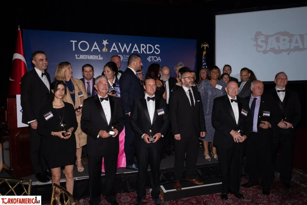 Honorees gathered on stage at a TOA Awards ceremony